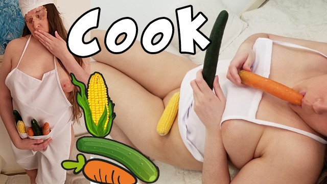 Chubby blonde cook inserting cucumber, carrot and corn